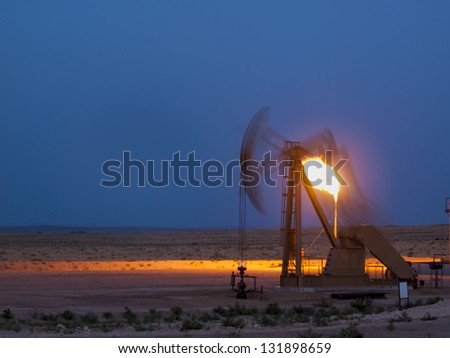 Pumpjack with flame at Pawnee National Grassland in Weld County, of northeastern Colorado.