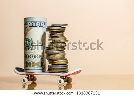 Hundred us dollare banknote and coins on the roller skates, fast return and high profit on professional investment.