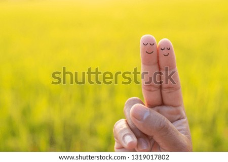 Finger couple in love with field background. 