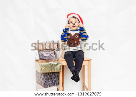 New Year. A child with a gift. Merry Christmas.Merry Christmas and happy holidays! Cute little child boy with xmas present. Santa Claus. Kid enjoy the holiday.