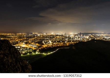 City lights from above showing panorama, sky and rocks at night, Edinburgh , Scotland, January 2019. 