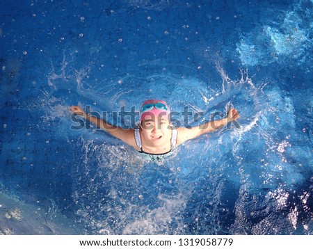 Japanese girl playing in the swimming pool