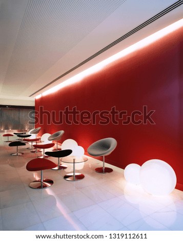 room with red wall, chair and lamps on the floor