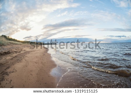 unfocused beach with sunset sky and sun. Beautiful soft colors, photographed on a fisheye lens