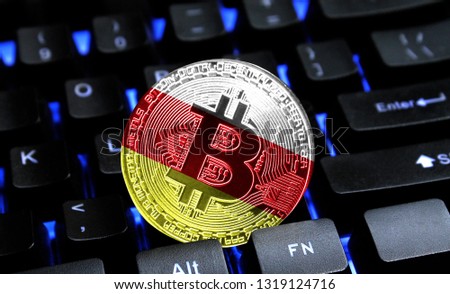 Bitcoin close-up on keyboard background, the flag of South Ossetia is shown on bitcoin.