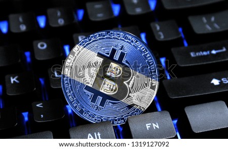 Bitcoin close-up on keyboard background, the flag of Nicaragua is shown on bitcoin.