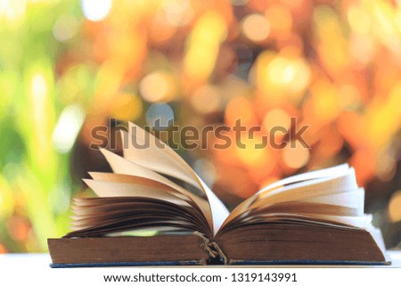 Close-up of old books that opened multicolored natural light as background selective focus and shallow depth of field