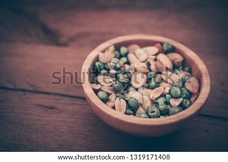 a peanut snack appetizer in a bowl on a wooden table