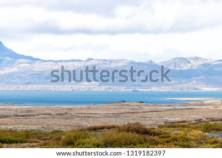 Landscape view of Thingvellir or Laugarvatn mountains and lake with clouds on golden circle in Iceland during day and blue color water in autumn