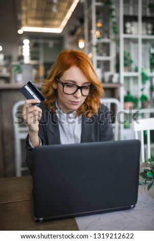 Young woman holding credit card and using laptop computer. Online shopping concept - Image
