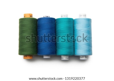 Rainbow colored sewing thread lined in a row