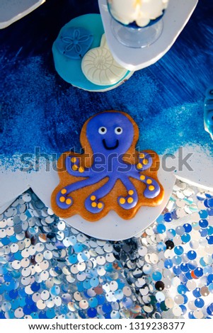 Homemade homemade gingerbread cookies in the form of crab, turtile, octopus and a starfish on the wooden table. Space for text and selective focus.