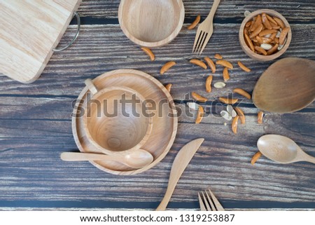 Design concept of wooden kitchenware utensils set on rustic wood background. Copy space for text and logo.