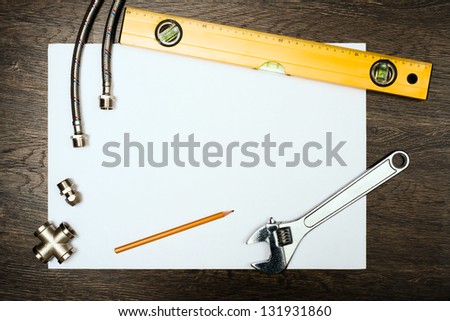 plumbing tools on a white sheet of paper, place for text
