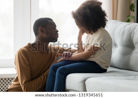 Loving african american dad comforting crying sad kid daughter holding hand supporting little stressed school girl in tears, black father consoling talking to upset child giving empathy protection Royalty-Free Stock Photo #1319345651