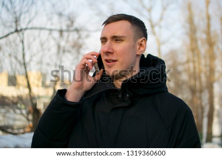 Man talking on the cell phone in the park