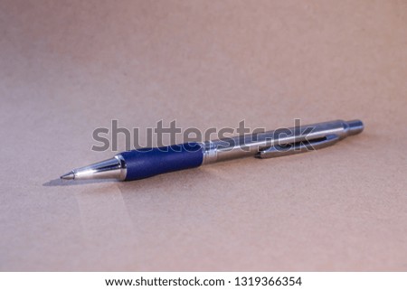 Metal blue ball point pen, A blue pen  on  writing paper, background