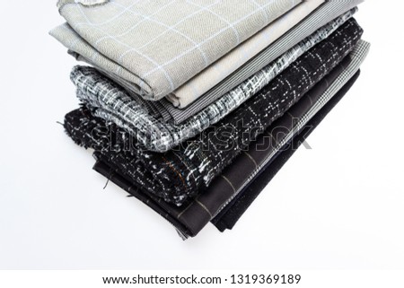 a stack of folded fabrics on a white background