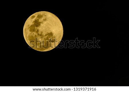 Super full moon, beautiful yellow moon with Black background of 20 February 2019 seen from Bangkok, Thailand.