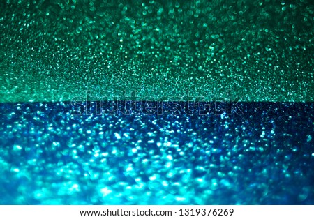 Bright blue and dark green, two tone defocused glitter texture background, same as sea in the night under stars sky.
