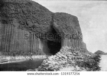 Columns of basalt at the entrance gate of Fingal Cave, Scottish Staffa Island, vintage engraved illustration. From the Universe and Humanity, 1910.
