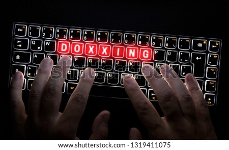 Doxxing Keyboard is operated by Hacker. Royalty-Free Stock Photo #1319411075