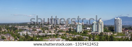 Aerial view of a modern city during a sunny summer day. Taken in Burnaby, Vancouver, BC, Canada.