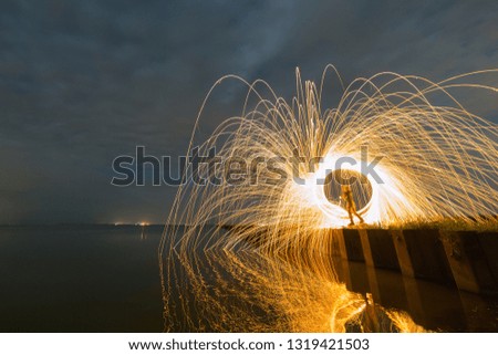 Freezelight with the steel wool on the long pier at night.