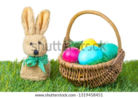 Easter bunny with colorful Easter eggs in a basket