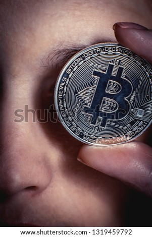 Bitcoin near the eyes of the girl