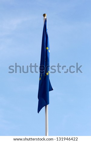 Limp European Union flag without wind  against the blue sky