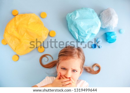 Plastic free concept. Say no plastics.Child and world of plastics. Plastic trash, plastic bags and garbage, straws. Plastic sun, sky, clouds. Environment pollution concept. . Royalty-Free Stock Photo #1319499644