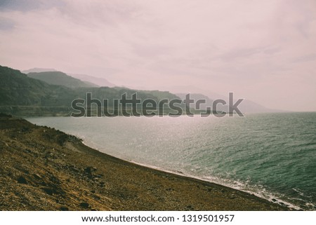 soft focus foggy and cloudy dramatic scenery landscape of waterfront mountain ridge along north sea shoreline