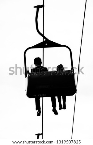 A father and daughter spend quality time together while enjoying a midway cable car ride on the Skyway at the CNE in Toronto.