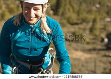 Portrait of rock climber preparing for climbing.