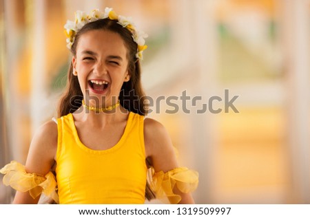 Portrait of laughing tween girl wearing ballet costume.