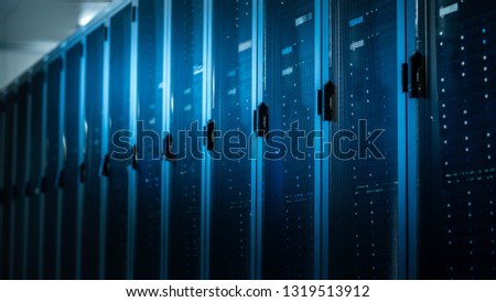 Low Angle Shot of a Working Data Center With Rows of Rack Servers. Led Lights Blinking and Computers are Working.
