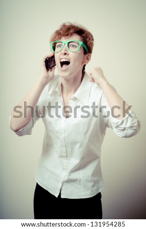 business woman calling on phone on gray background