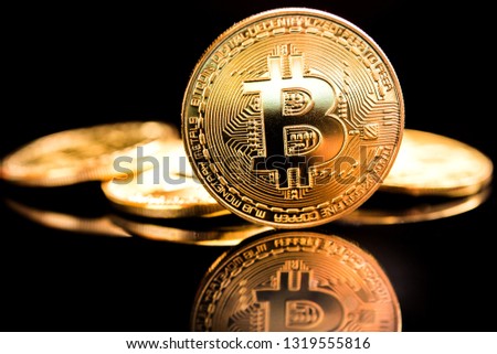 Photo Golden Bitcoins new virtual money with black backround 