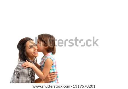 Portrait of happy daughter kissing her mother, isolated on white background