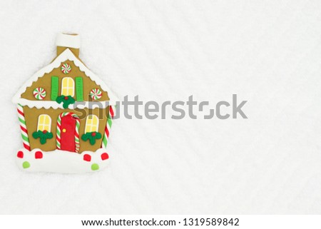 Christmas gingerbread house on white chevron textured fabric background that you can use as a mock up for your message for Christmas