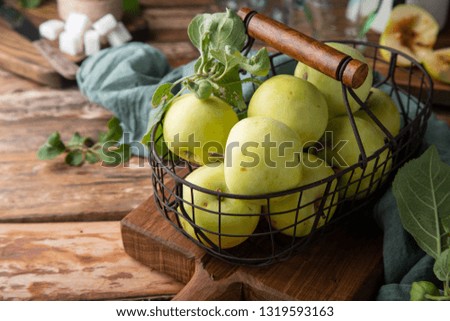 Organic green apples in metal basket on rustic wooden background