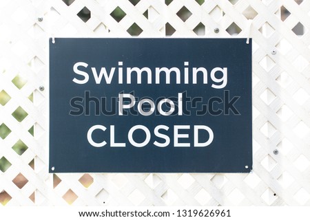 A sign stating that the swimming pool is closed