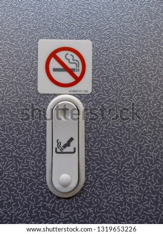Modern small ashtray on a commercial airplane. The FAA requires an ashtray both inside and outside airplane bathrooms, even on planes manufactured since the smoking ban, to prevent fires