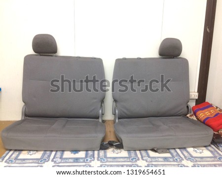 Old sofas, car seats, old leaning on a white wall