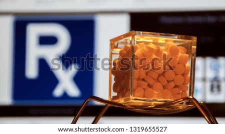 Medicine like tablets and round pills with computer display background with pharmacy and money signs logo
