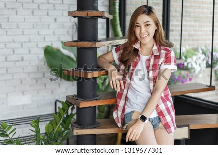 portrait of happy woman sitting on wooden stair