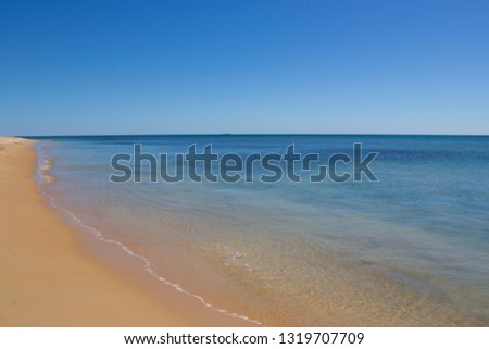 Beautiful scenic views of   access to   pristine Binningup Beach Western Australia on a sunny afternoon in late  summer highlights the peaceful Indian Ocean lapping on the sandy shore.