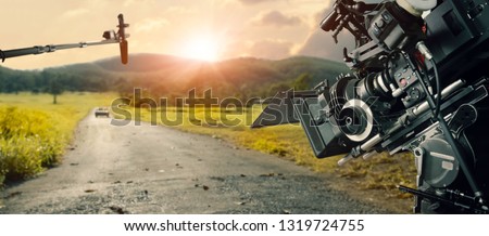 Behind the scenes making of movie and TV commercial. Camera of movie and video production. Film Crew. B-roll, and crew team in outdoor nature background. Royalty-Free Stock Photo #1319724755