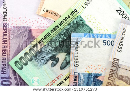 Several Indonesian rupiah banknotes close up as background